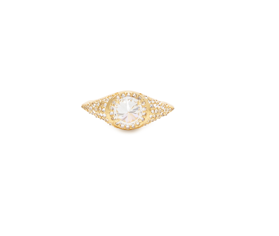 The Up Signet Ring by Nijma M Fine Jewelry boasts intricate and delicate filigree detailing around a large, central, round-cut diamond. Crafted from 18K yellow gold, its design is ornate and symmetrical, emphasizing the brilliance of the diamond at its center. The background is plain white.